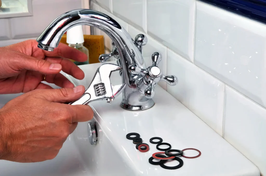 Plumber performing maintenance on a bathroom faucet in Cape Coral