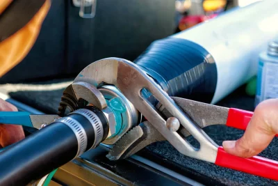 Technician tightening an industrial pipe connection in Cape Coral