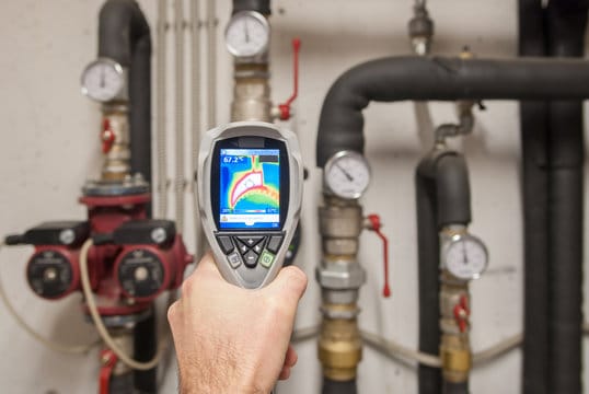 Plumber using a thermal imaging camera to inspect pipes in Cape Coral