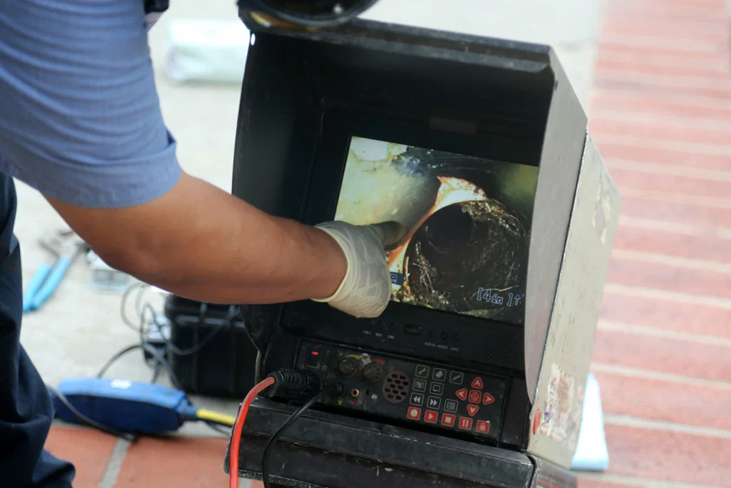Technician viewing a drain inspection camera in Cape Coral