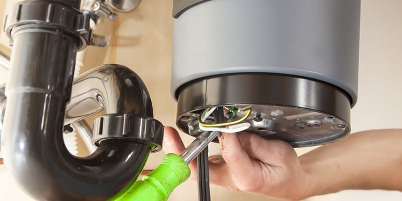 Technician repairing the heating element of a water heater in Cape Coral