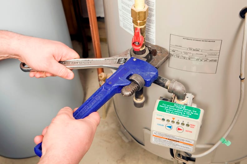 Plumber repairing a water heater valve in Cape Coral